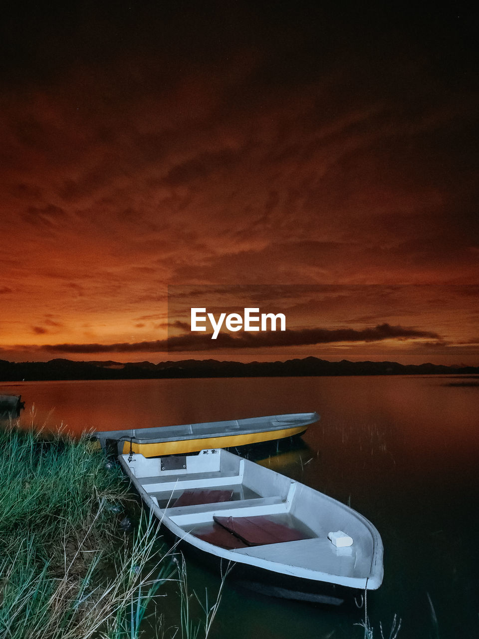 Scenic view of lake against sky during sunset