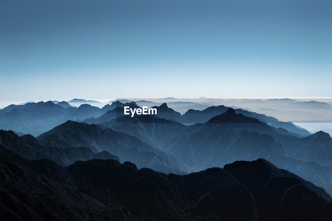 Scenic view of mountains against clear blue sky