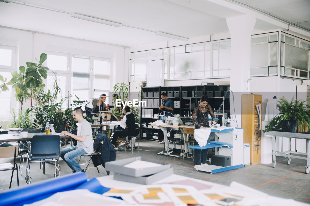 Male and female entrepreneurs working in creative office