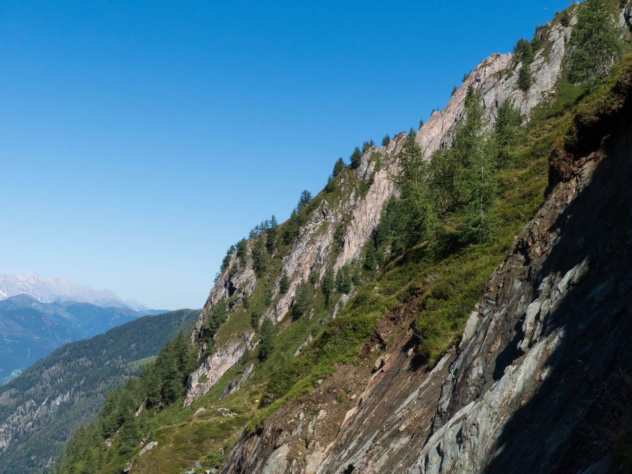 Scenic view of mountains against clear blue sky