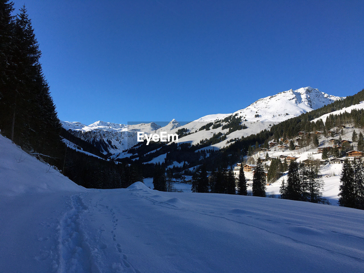 SNOW COVERED MOUNTAIN AGAINST CLEAR BLUE SKY