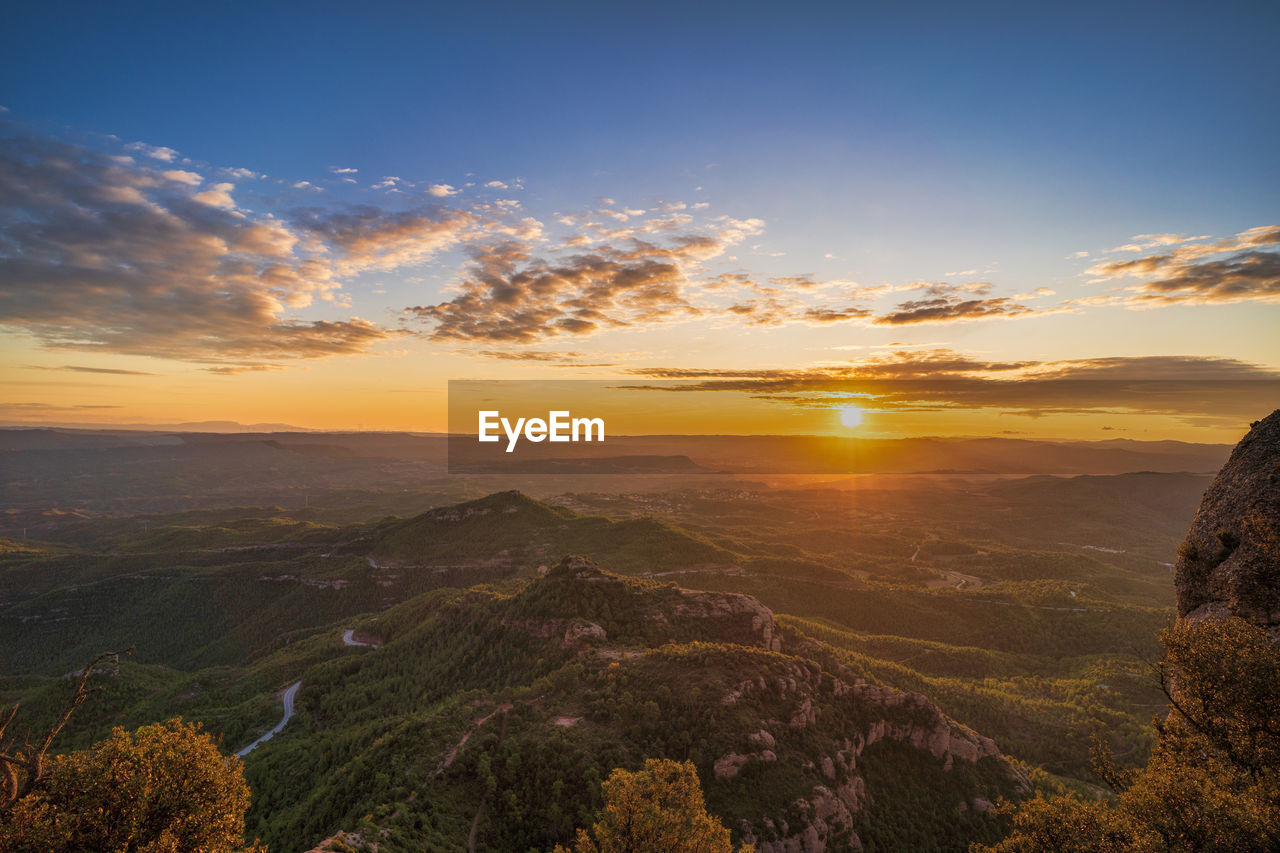 SCENIC VIEW OF LANDSCAPE AGAINST ORANGE SKY