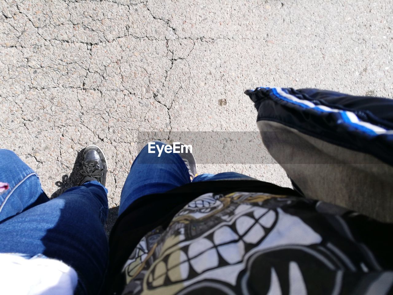 LOW SECTION OF MAN WEARING SHOES STANDING ON FLOOR