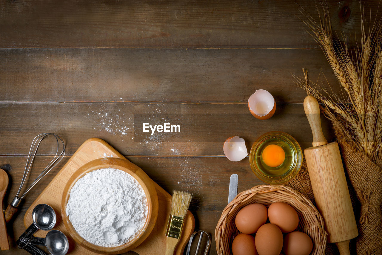 Bread flour with fresh egg and accessories bakery on wood background,