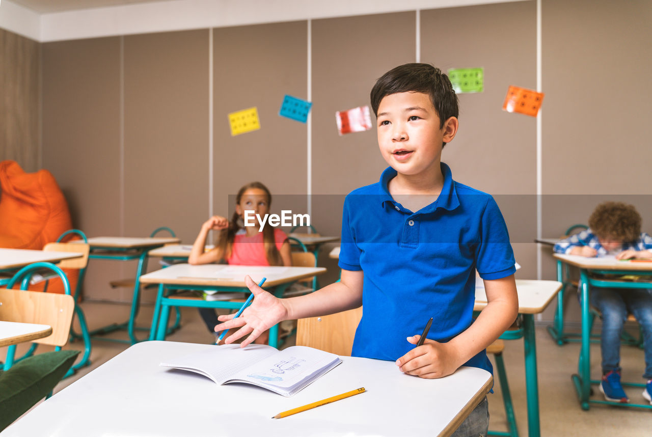 Full length of boy standing on table