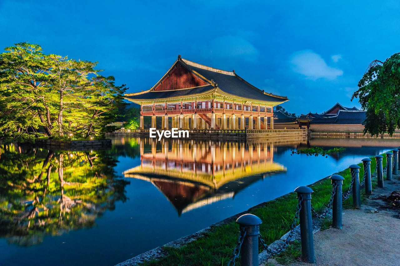 VIEW OF BUILDING BY LAKE