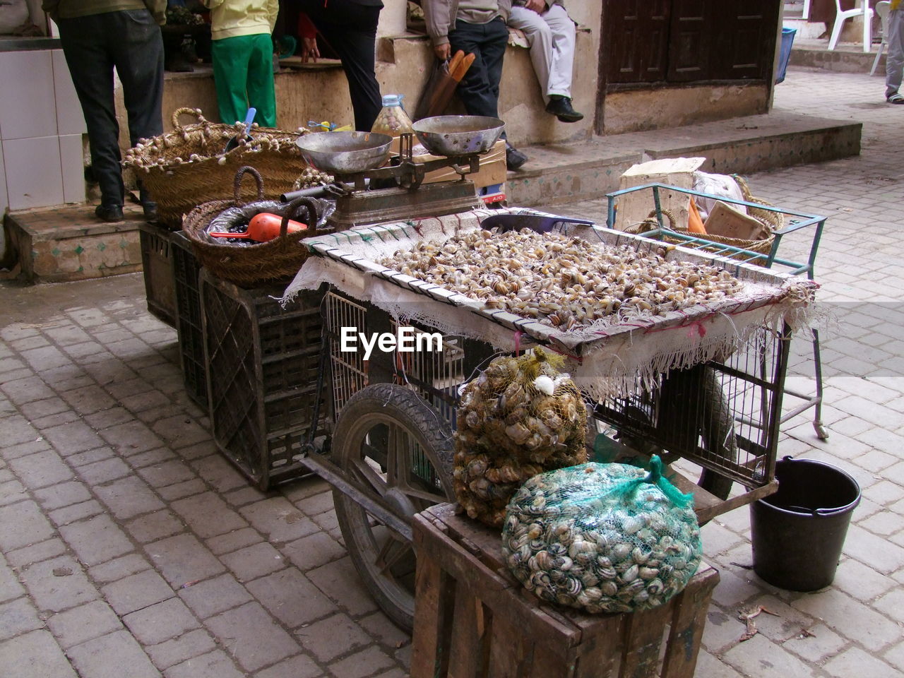 WOMAN IN MARKET FOR SALE AT STREET