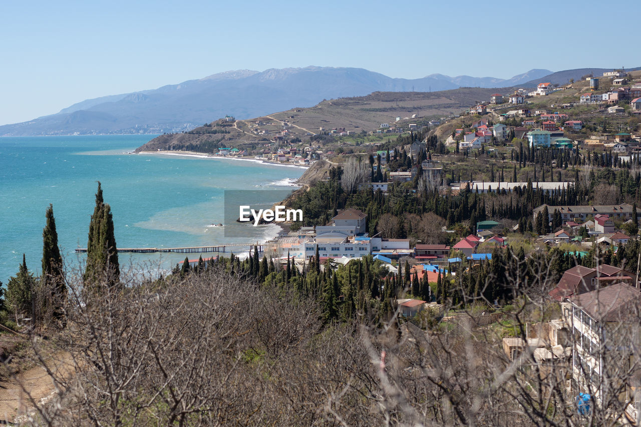 Panoramic shot of city by sea against sky