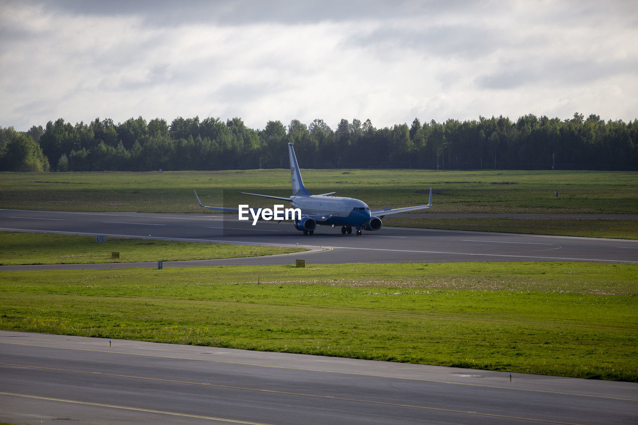 car on airport runway against sky