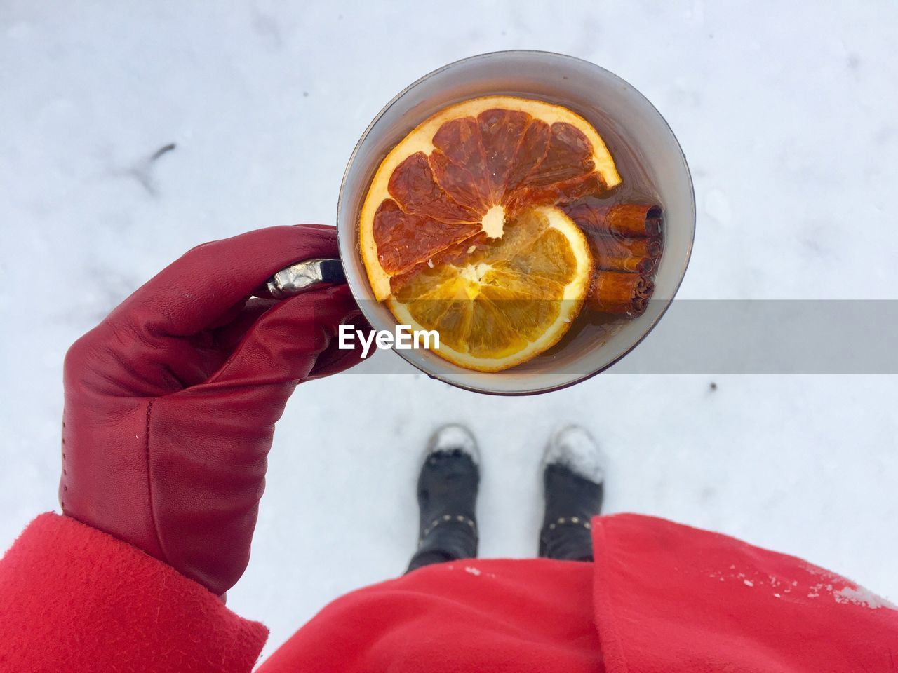 High angle view of woman holding drink during winter