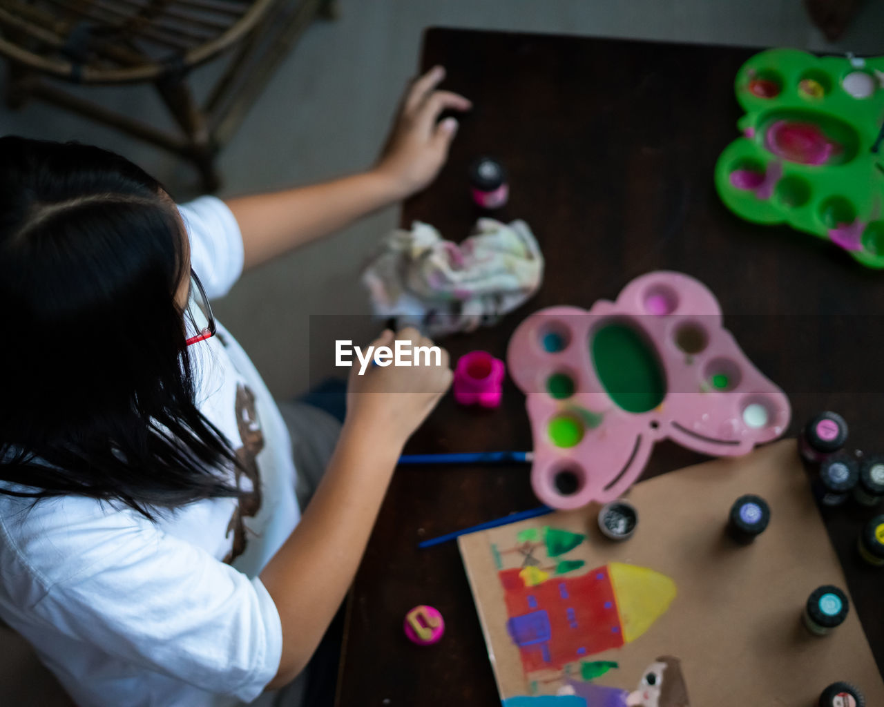 High angle view of girl painting at desk