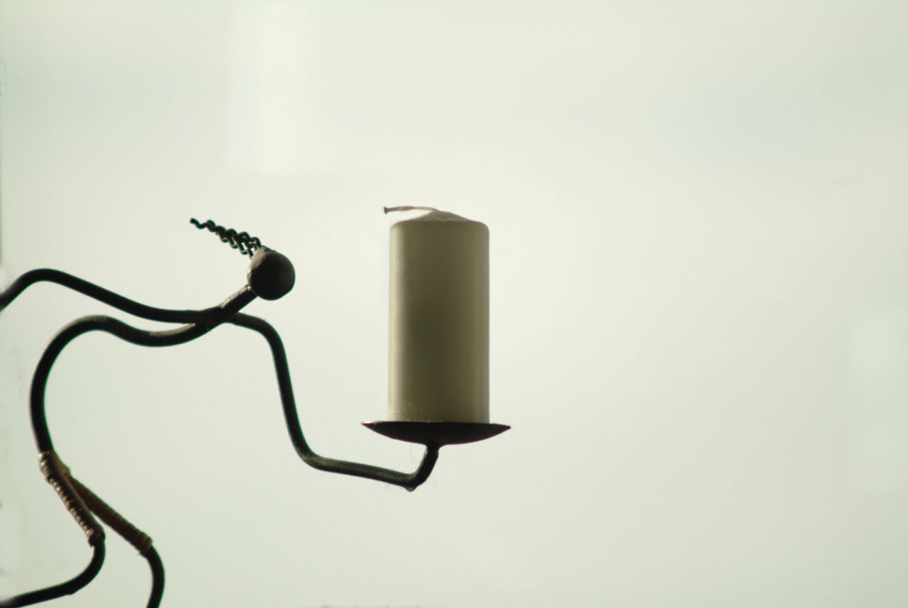 CLOSE-UP OF ELECTRIC LAMP OVER WHITE BACKGROUND