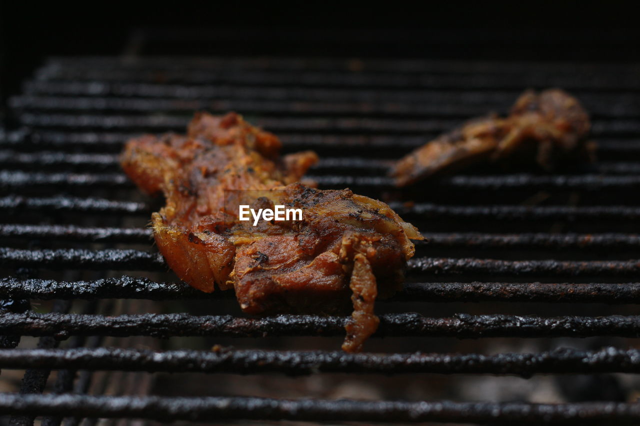 CLOSE-UP OF MEAT ON BARBECUE