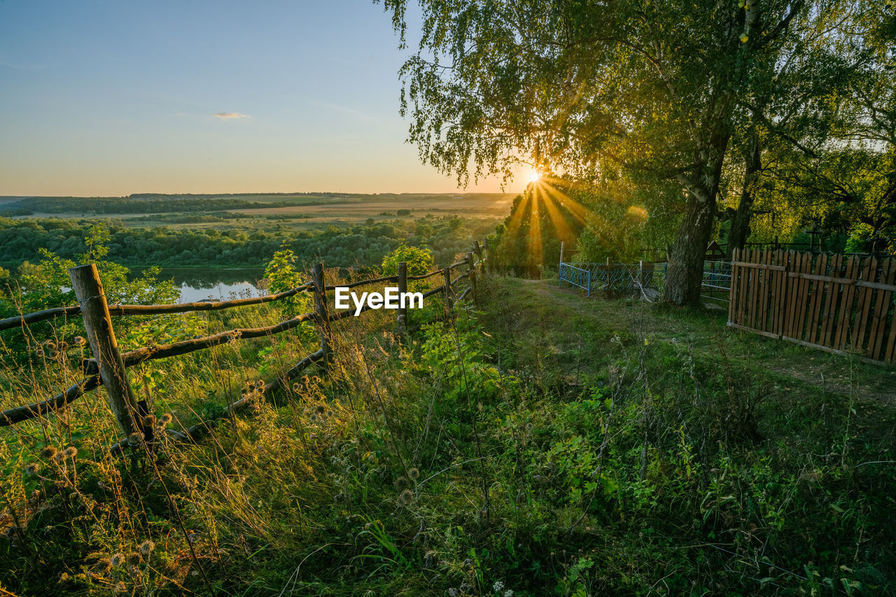 Scenic view of field against sky during sunset