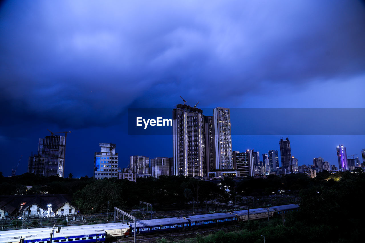 MODERN BUILDINGS AGAINST SKY AT NIGHT