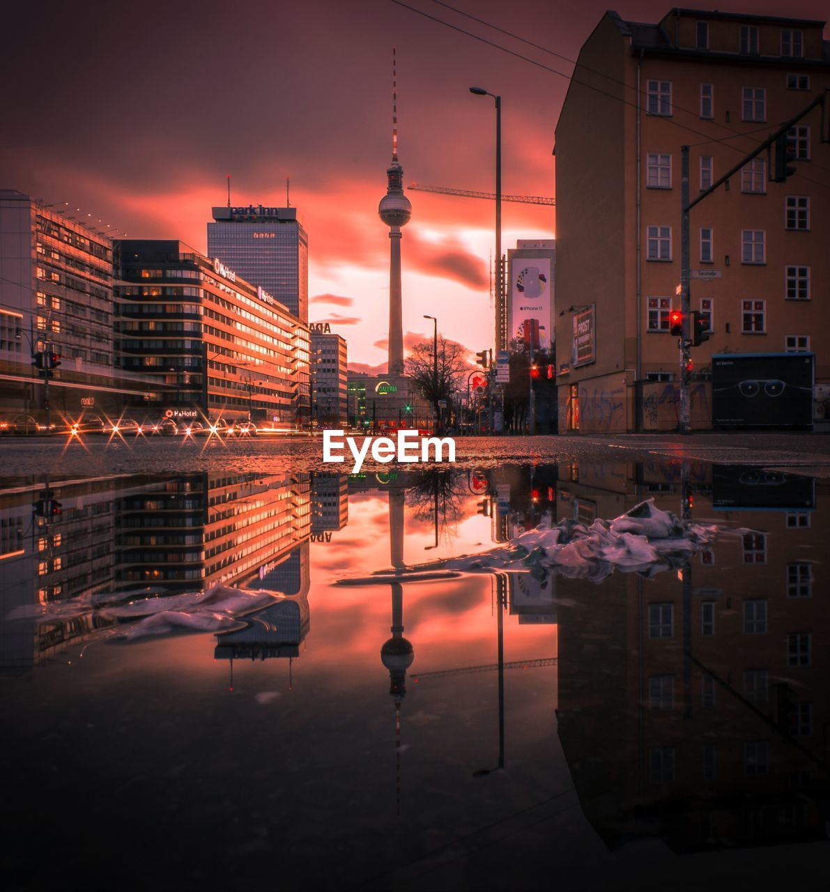 Reflection of buildings in city at sunset