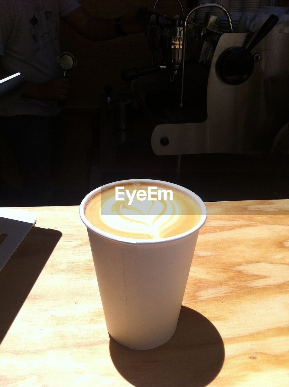 Disposable coffee cup on table