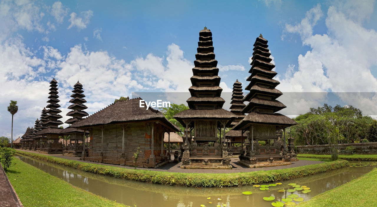 TEMPLE AGAINST BUILDING AND SKY