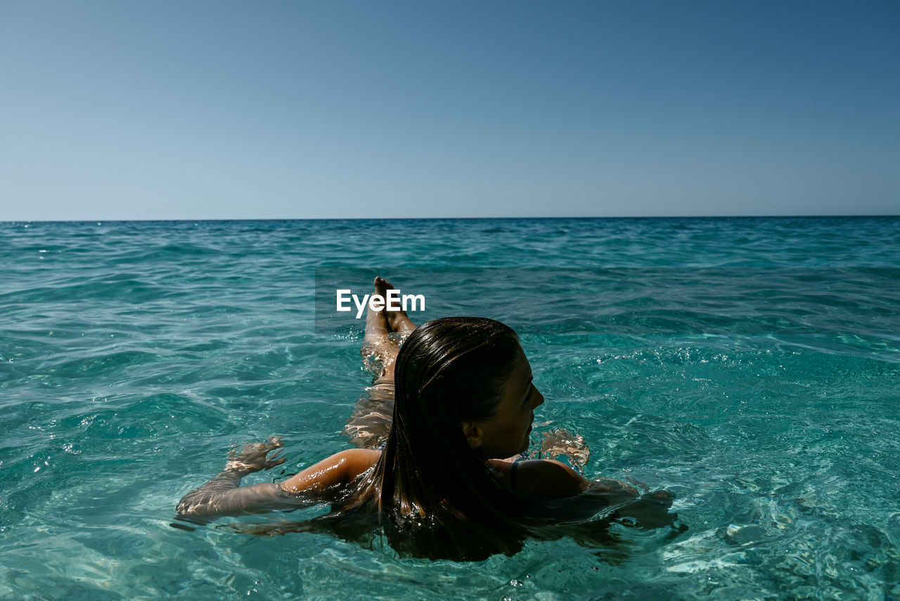 Young woman swimming in sea