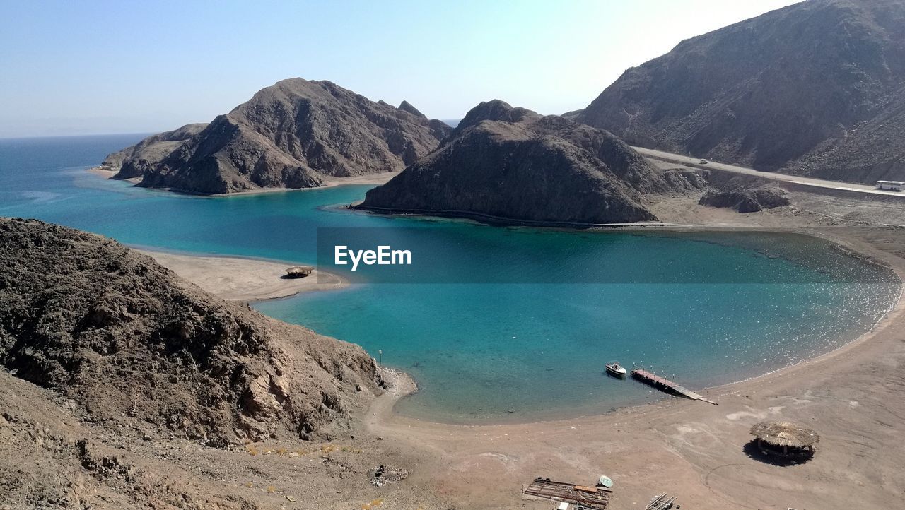 PANORAMIC VIEW OF SEA AND MOUNTAINS AGAINST CLEAR SKY