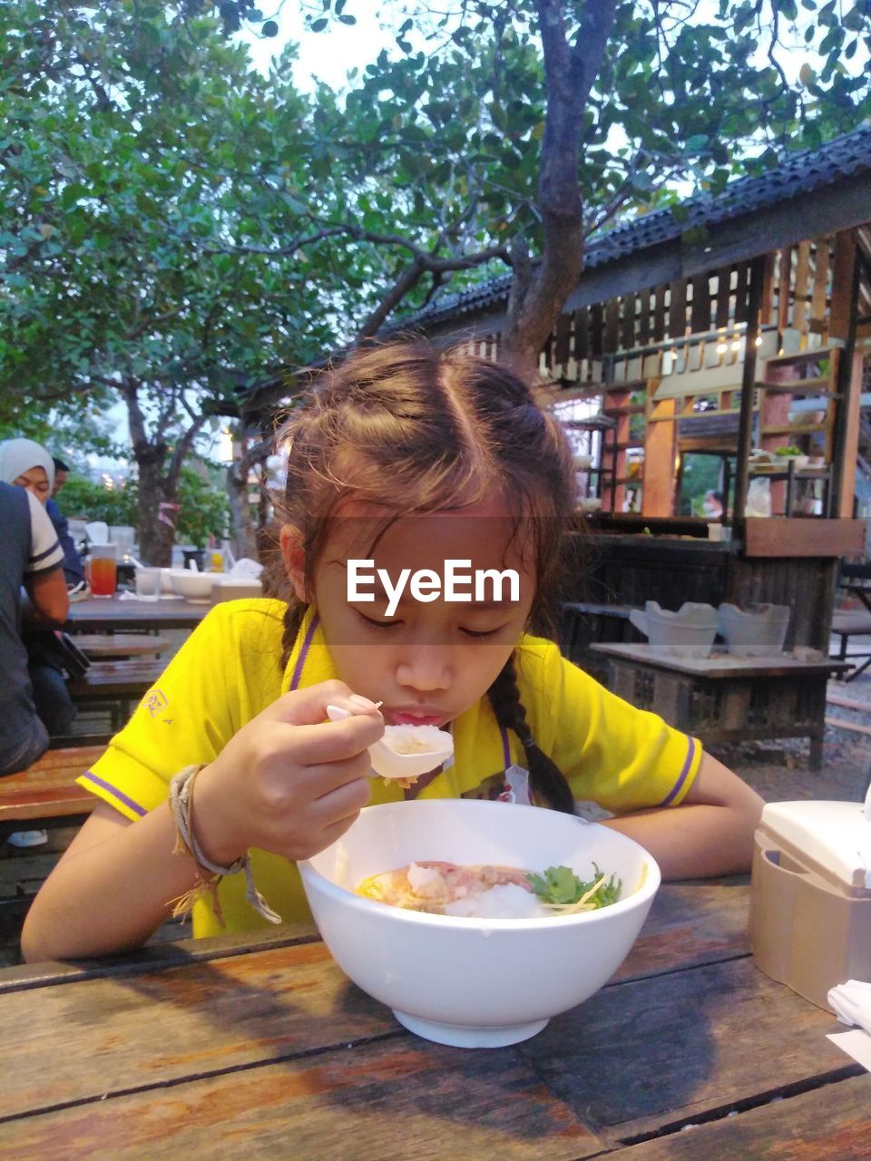 Cute girl eating food at restaurant