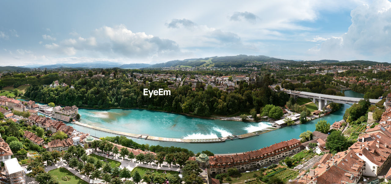 High angle view of bay and cityscape against sky