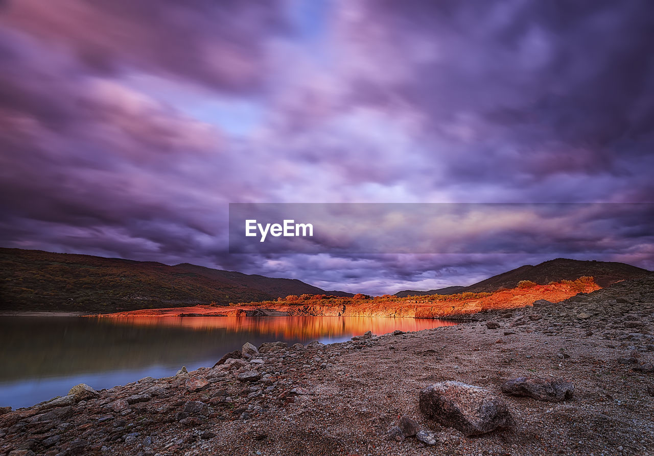 Scenic view of lake against sky during sunset