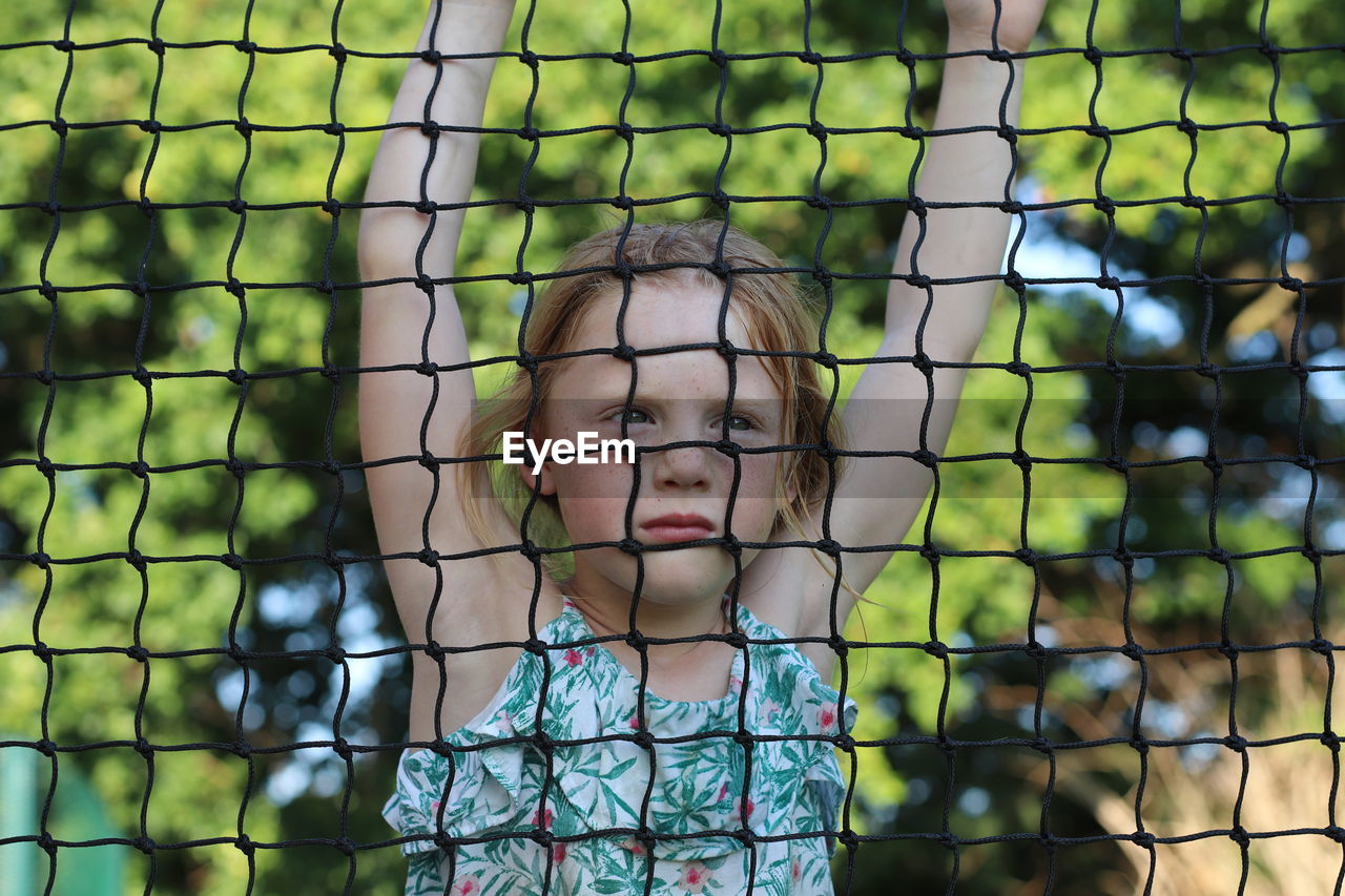 Portrait of girl seen net