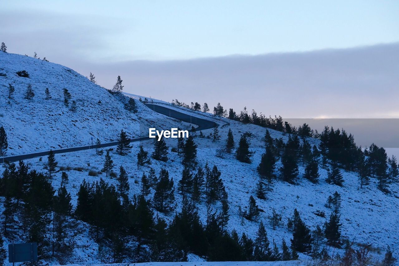 SNOW COVERED LANDSCAPE AGAINST SKY