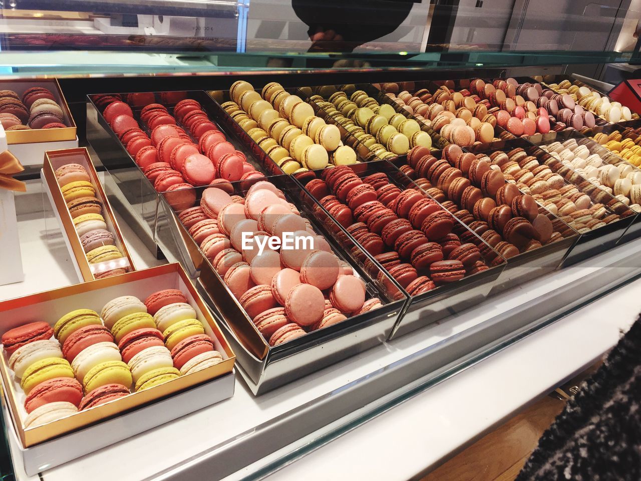 High angle view of macaroons in containers for sale