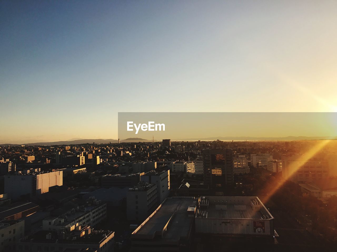 High angle view of illuminated cityscape against sky during sunset