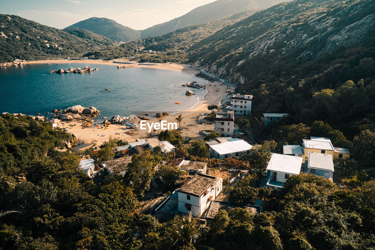 High angle view of townscape by sea