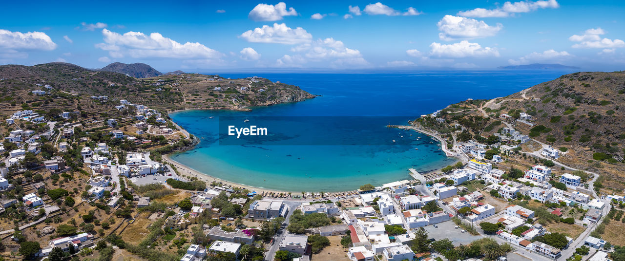 high angle view of townscape by sea against sky