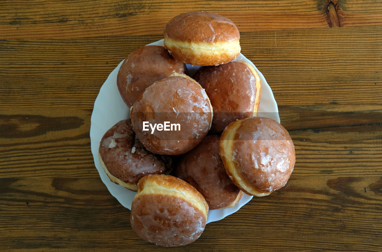 High angle view of doughnuts on wooden table