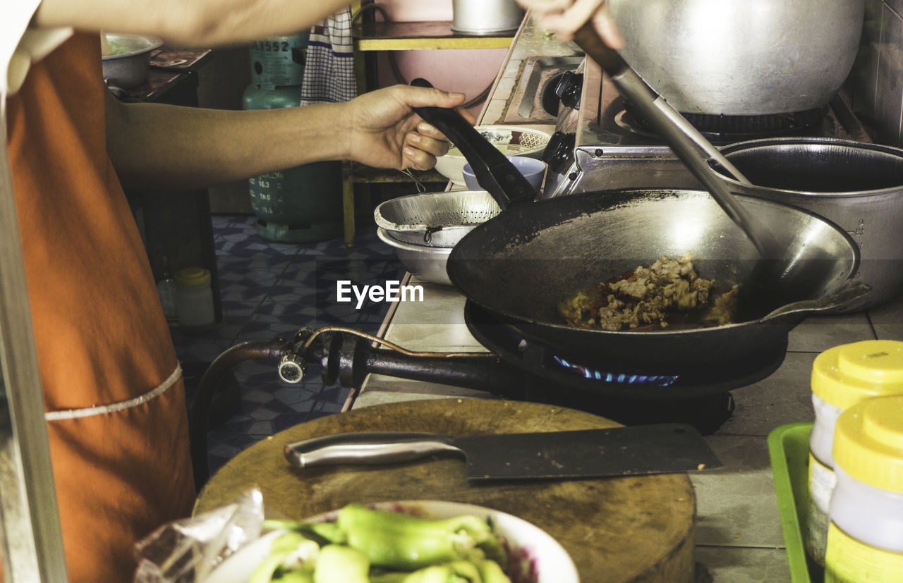 Midsection of man preparing food in kitchen