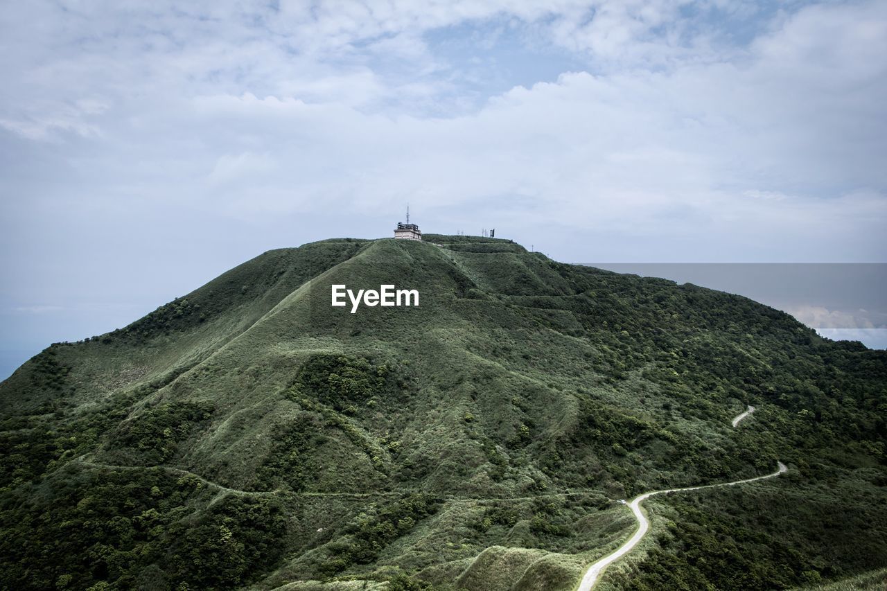 Scenic view of cross on mountain against sky