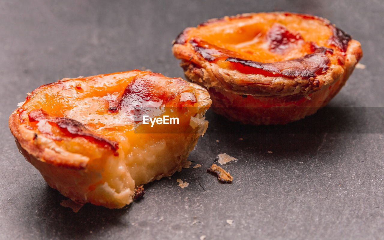 Close up of portuguese 'pasteis de nata', custard tart on a dark background