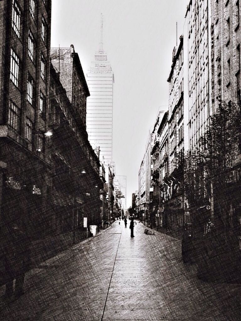 PEOPLE WALKING ON STREET AMIDST BUILDINGS IN CITY