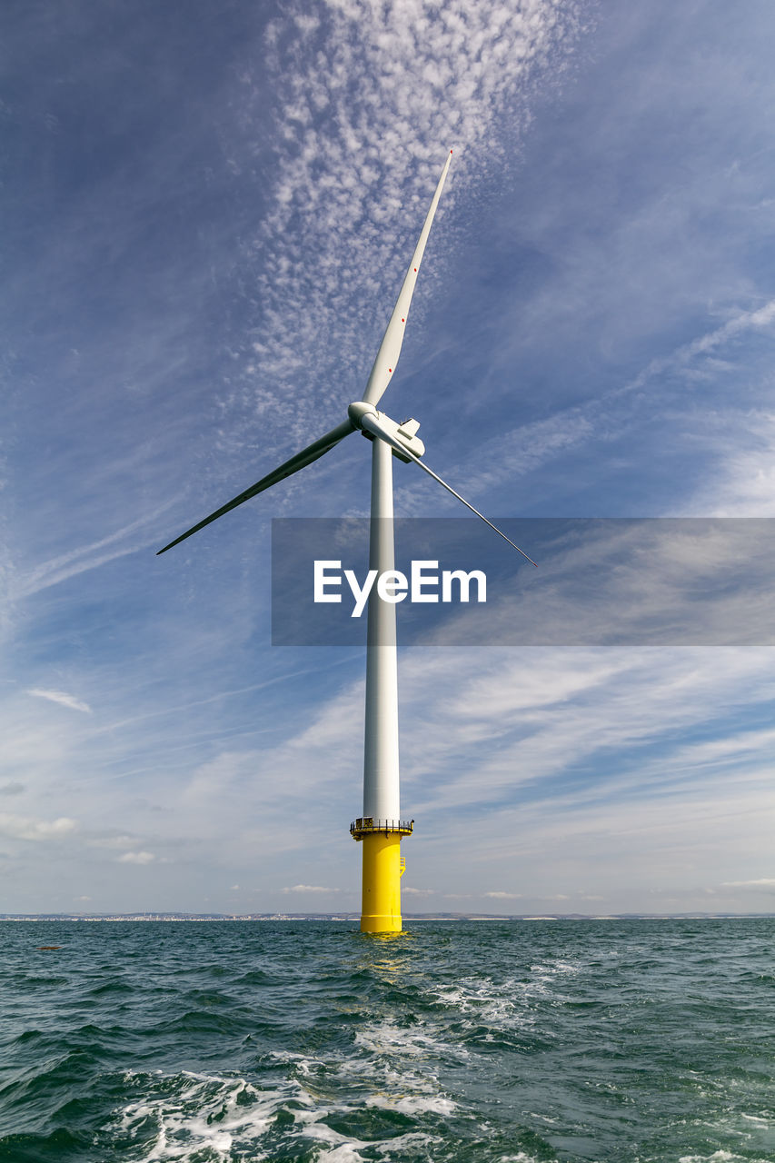 WINDMILL ON SEA AGAINST SKY