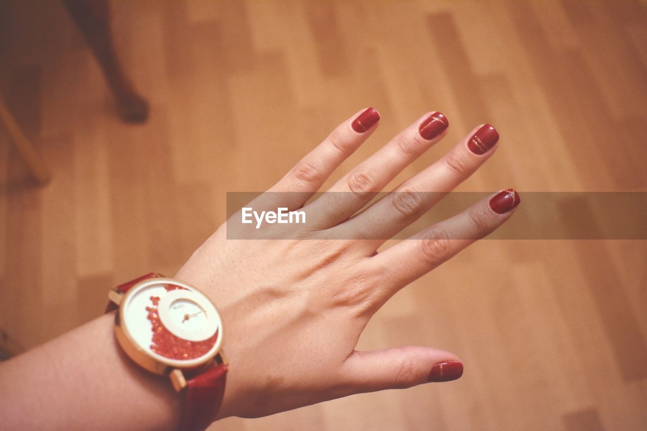 Cropped hand of woman with red nails