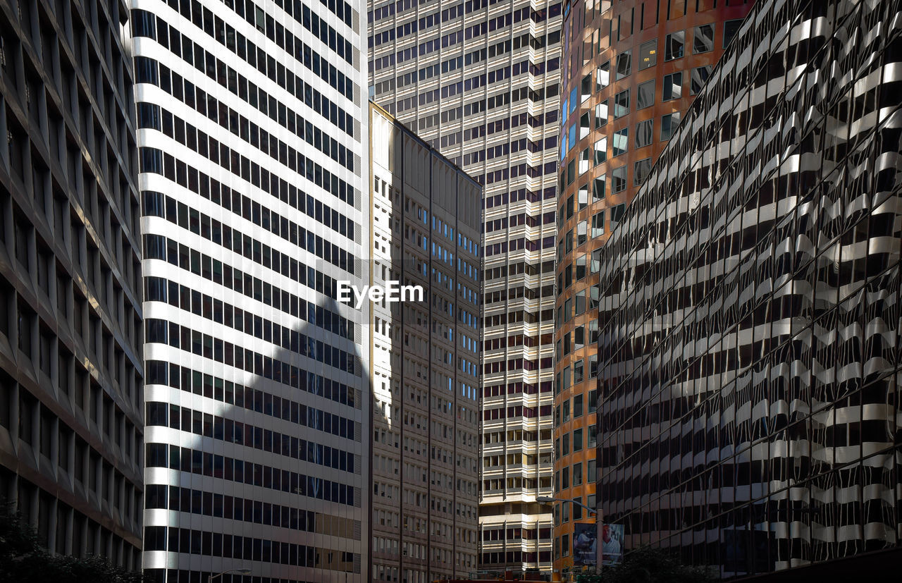 Full frame shot of modern office buildings in city
