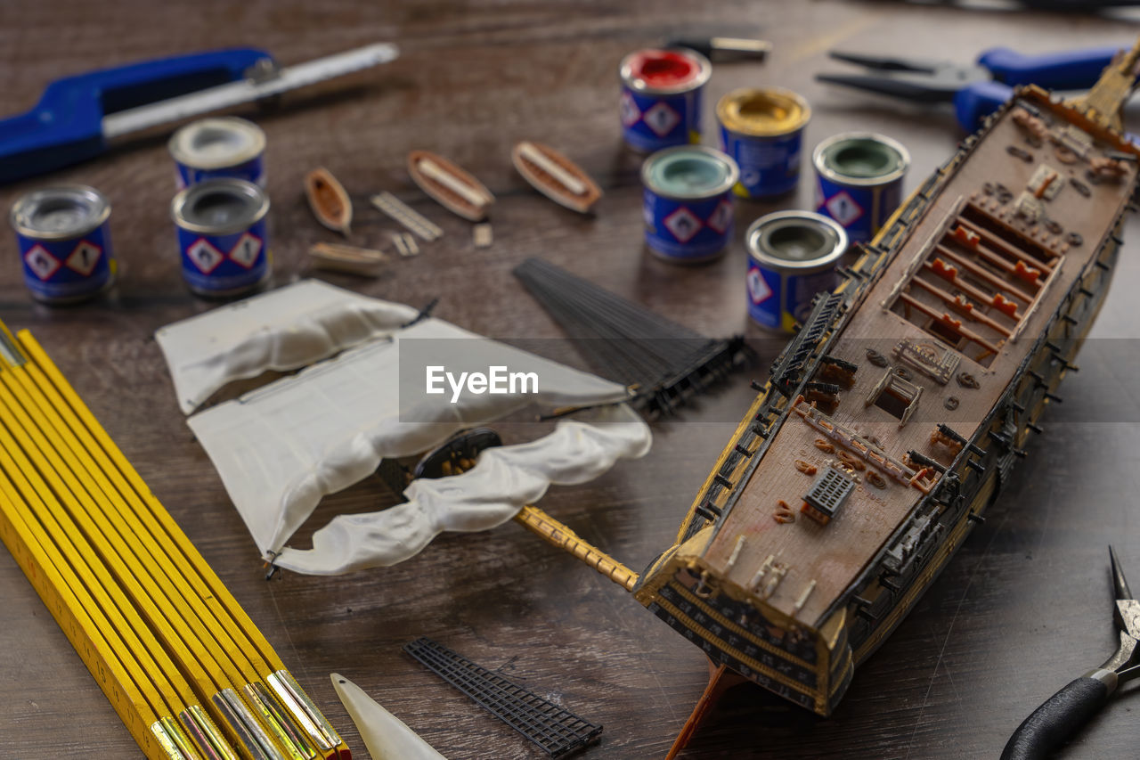 work tool, indoors, craft, workshop, table, workbench, no people, equipment, creativity, high angle view, scissors, wood, occupation, brush, paintbrush, tool, still life, hand tool, art