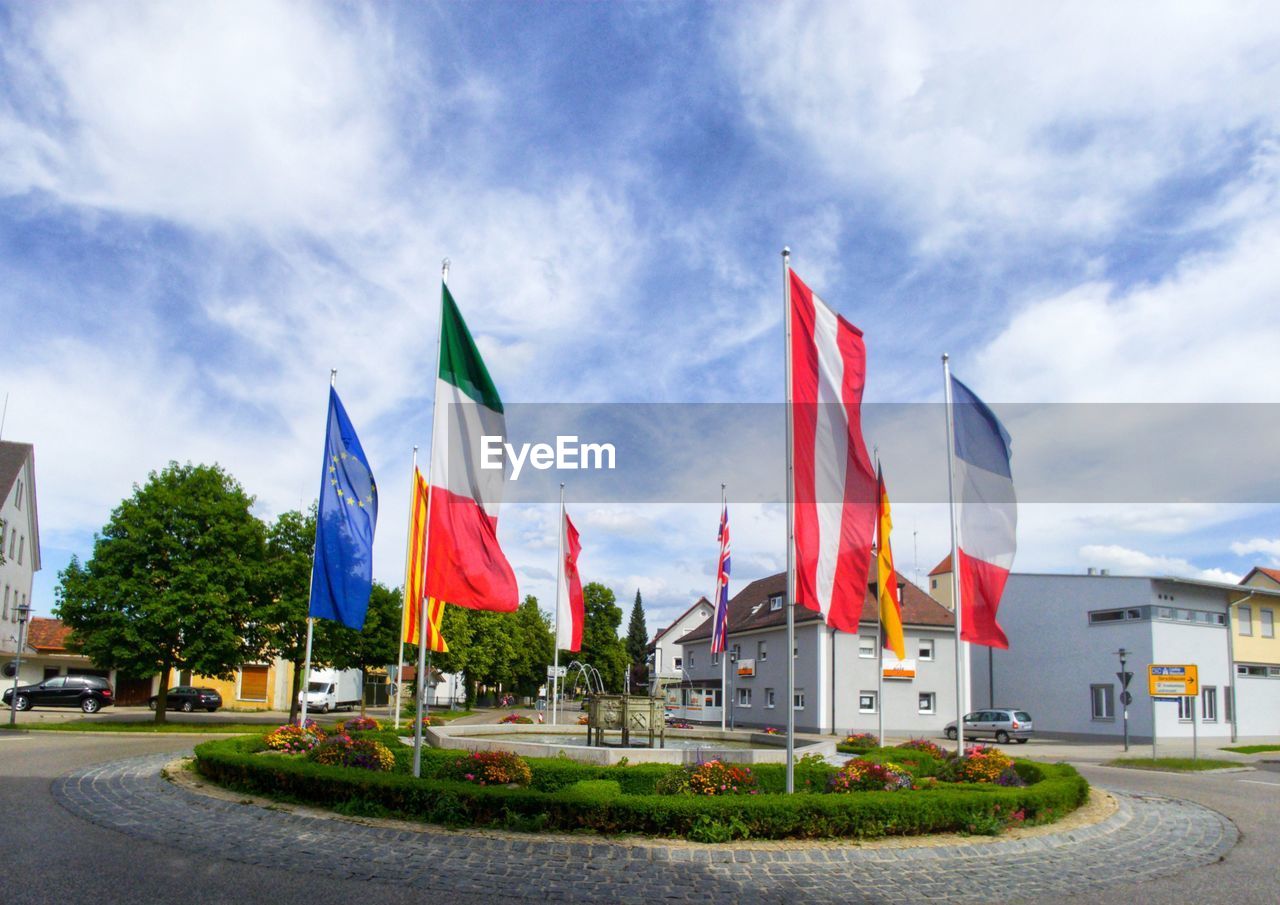 FLAG BY BUILDING AGAINST SKY