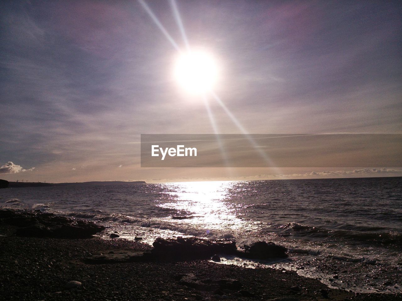 Scenic view of sea against sky on sunny day