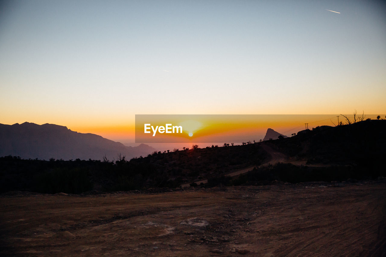 SUNSET OVER LANDSCAPE