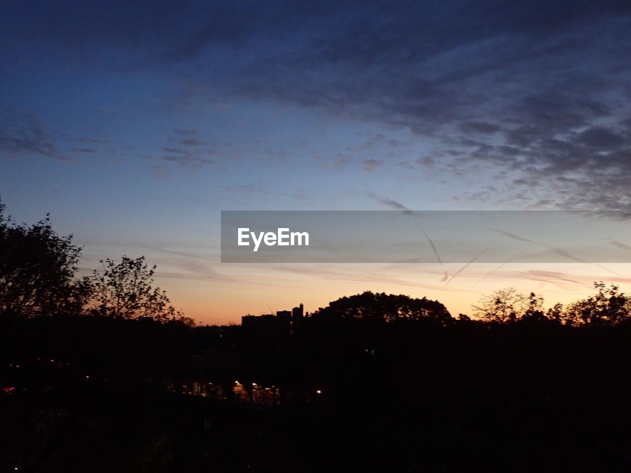 SCENIC VIEW OF SILHOUETTE TREES AGAINST SKY AT SUNSET