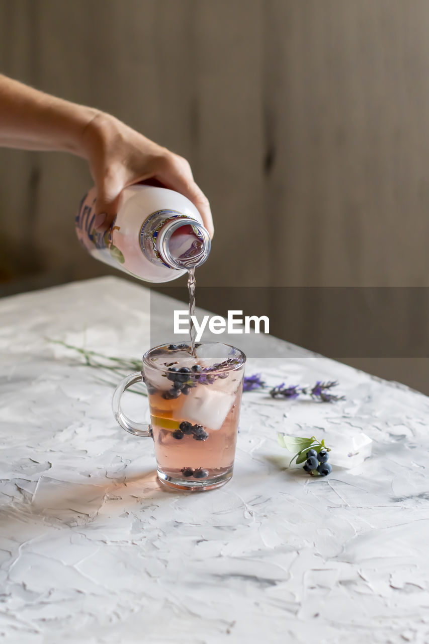 Cold refreshing tea with blueberry, lime and lavender on a hot summer day
