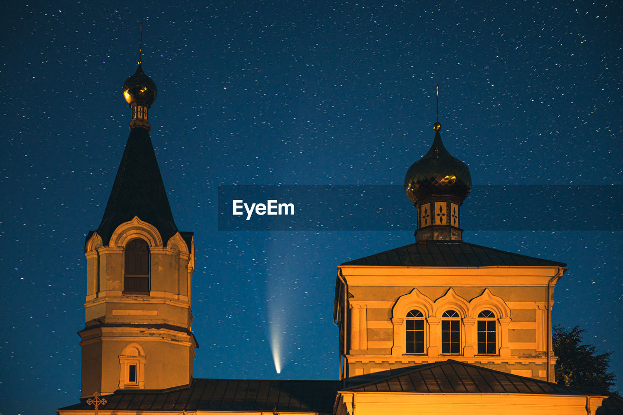 View of buildings against sky at night