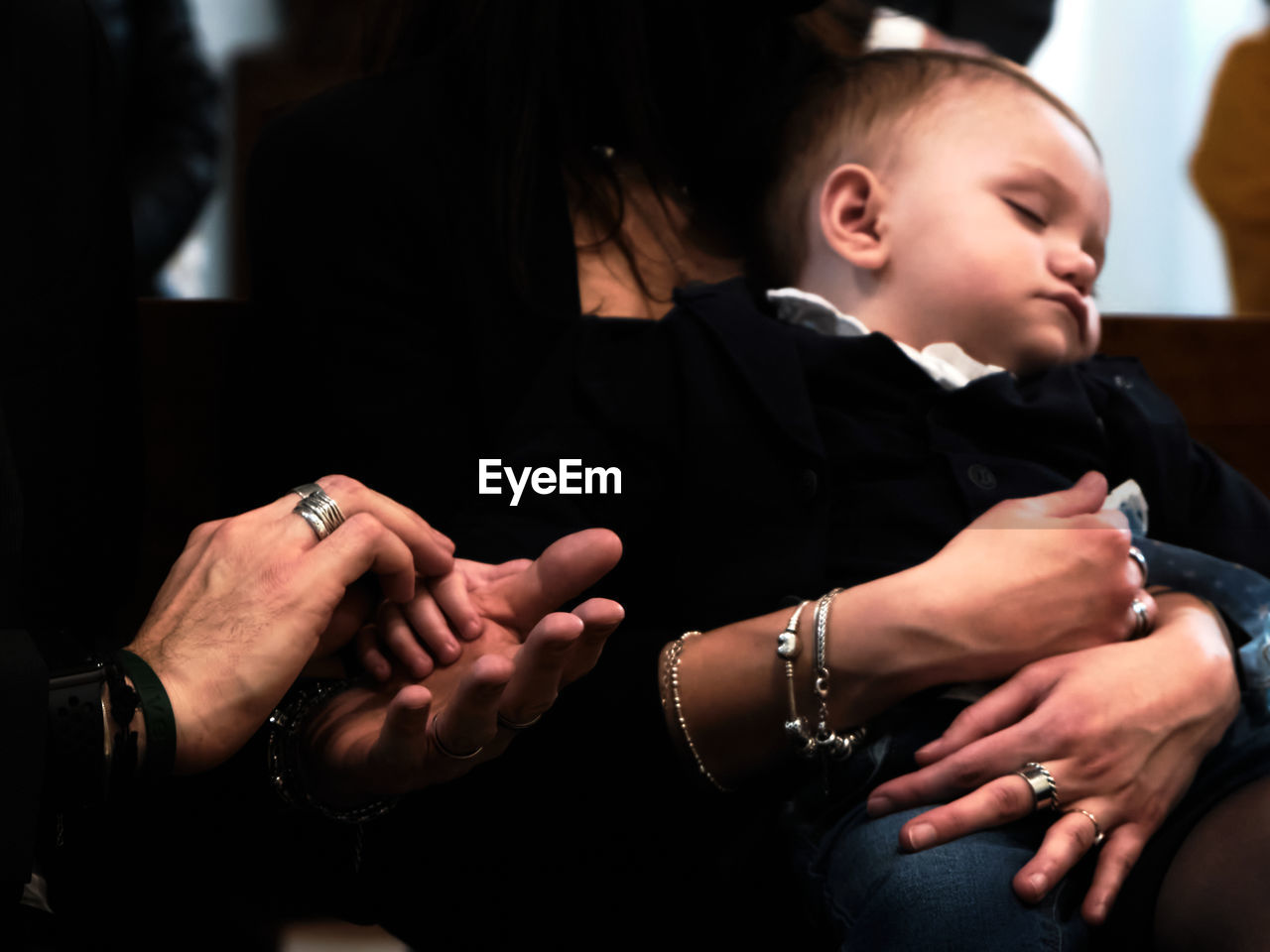 Midsection of mother, father and baby hands