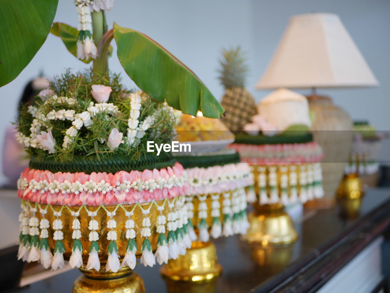 CLOSE-UP OF POTTED PLANT ON TABLE BY BUILDING